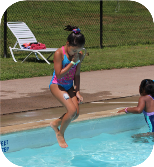Girl jumping into the pool on a sunny summer day at the Connecticut Lions Club Camp at Mountain Mist Day Camp for children with Type 1 diabetes. 